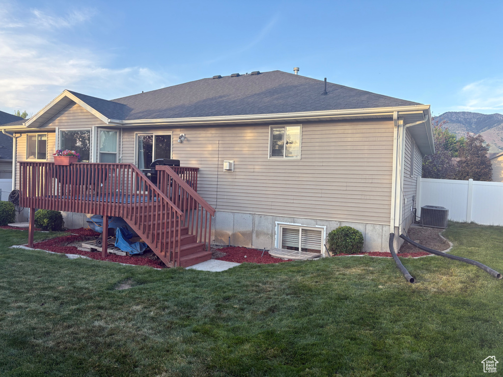 Rear view of property with a wooden deck and stairs