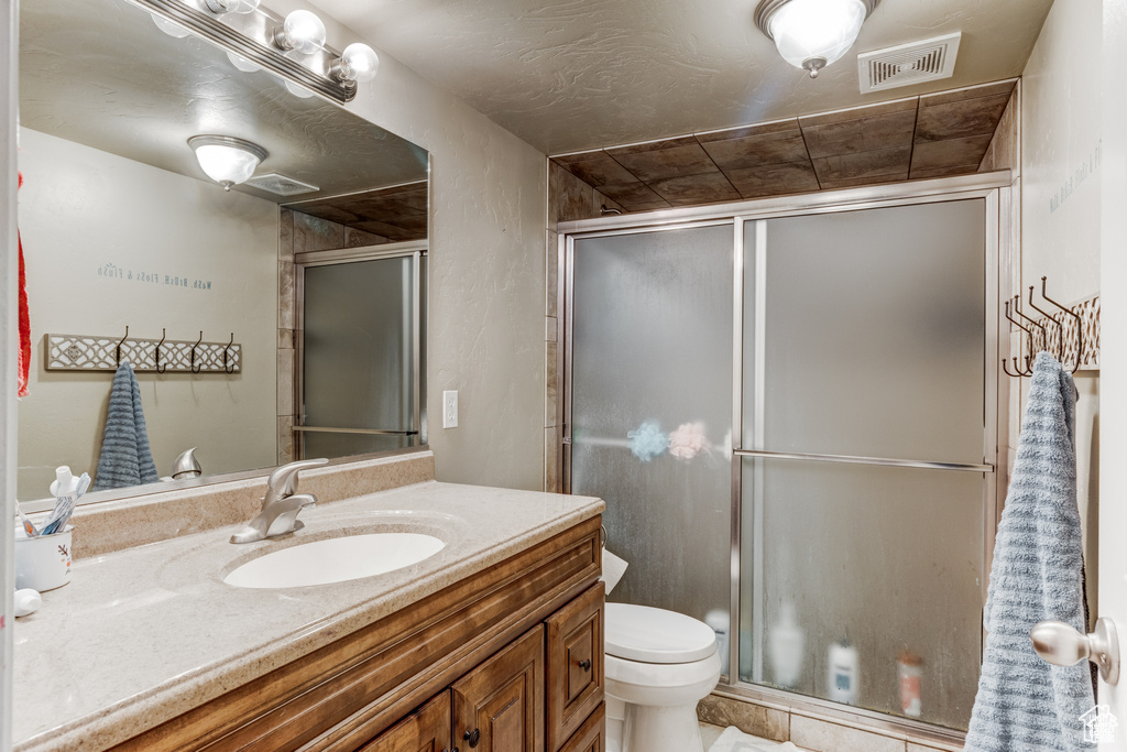Bathroom with vanity and a stall shower