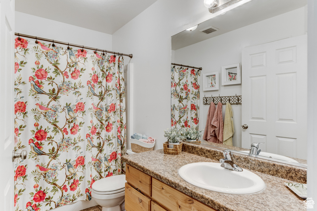 Bathroom with vanity and a shower with shower curtain