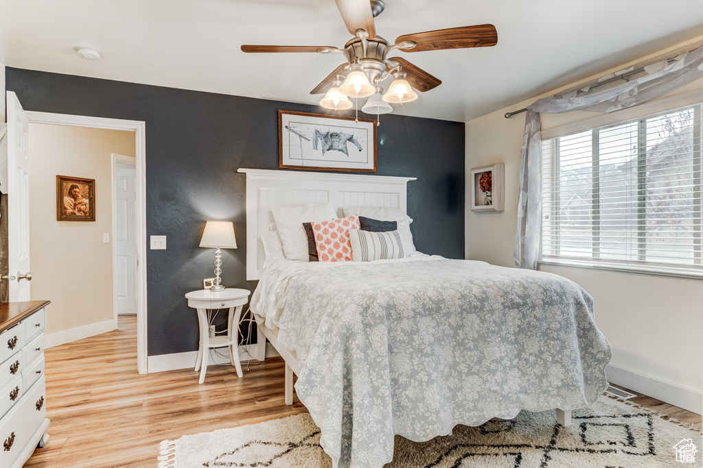 Bedroom with light wood finished floors and ceiling fan