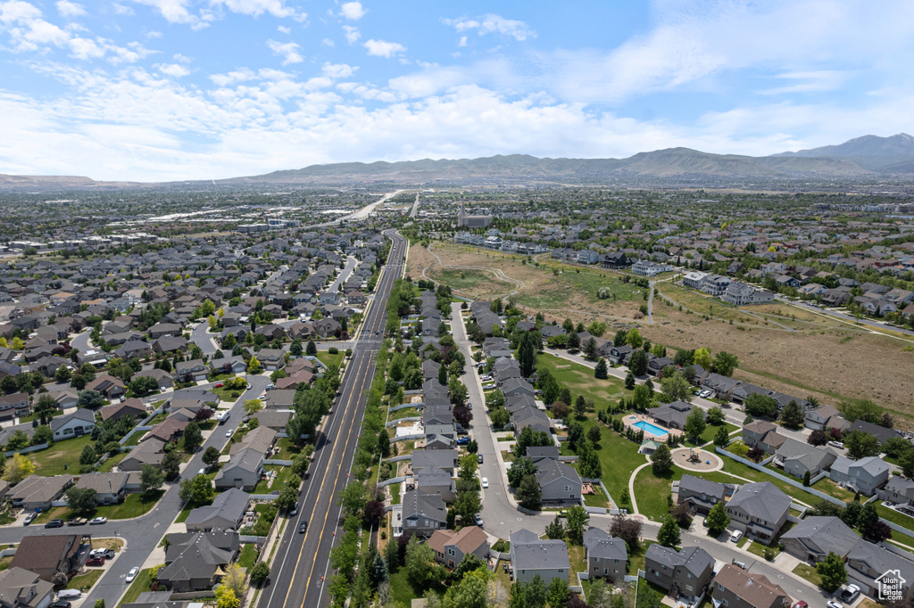 Aerial overview of property\'s location with a mountainous background and nearby suburban area