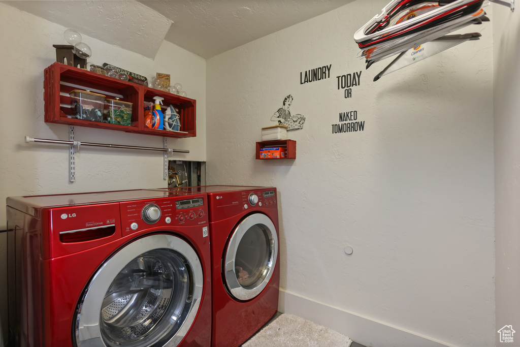Laundry area featuring washing machine and clothes dryer and carpet floors