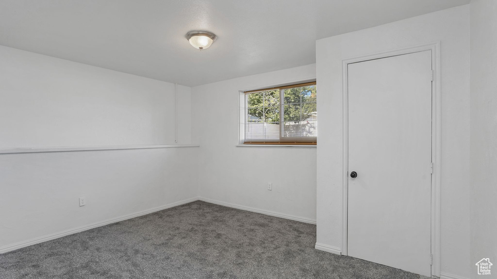 Unfurnished bedroom with carpet floors and baseboards