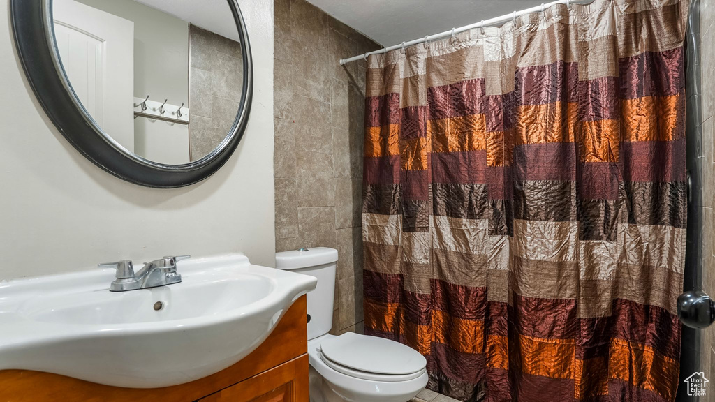 Bathroom featuring vanity and curtained shower