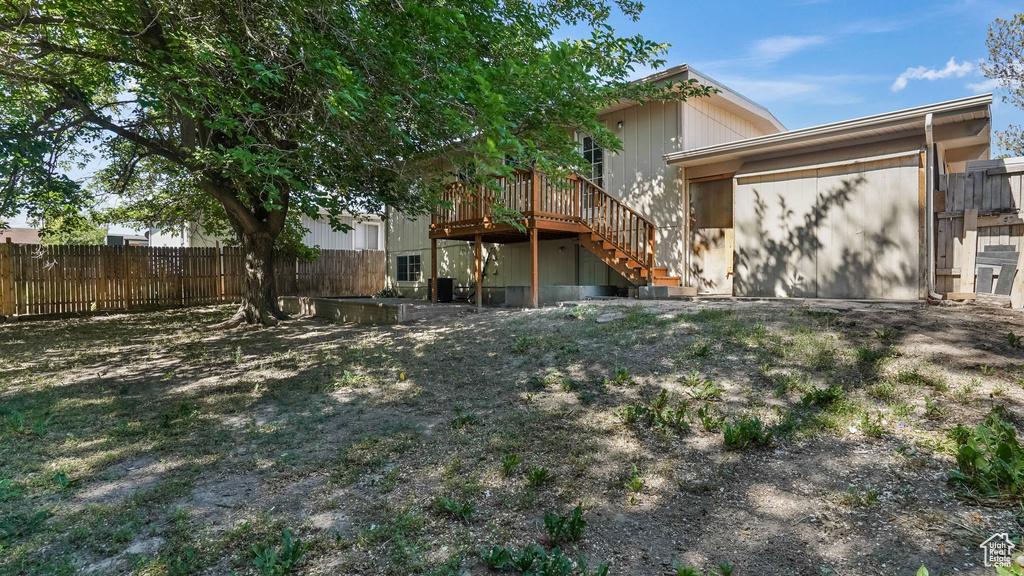 Back of property with stairway and a wooden deck