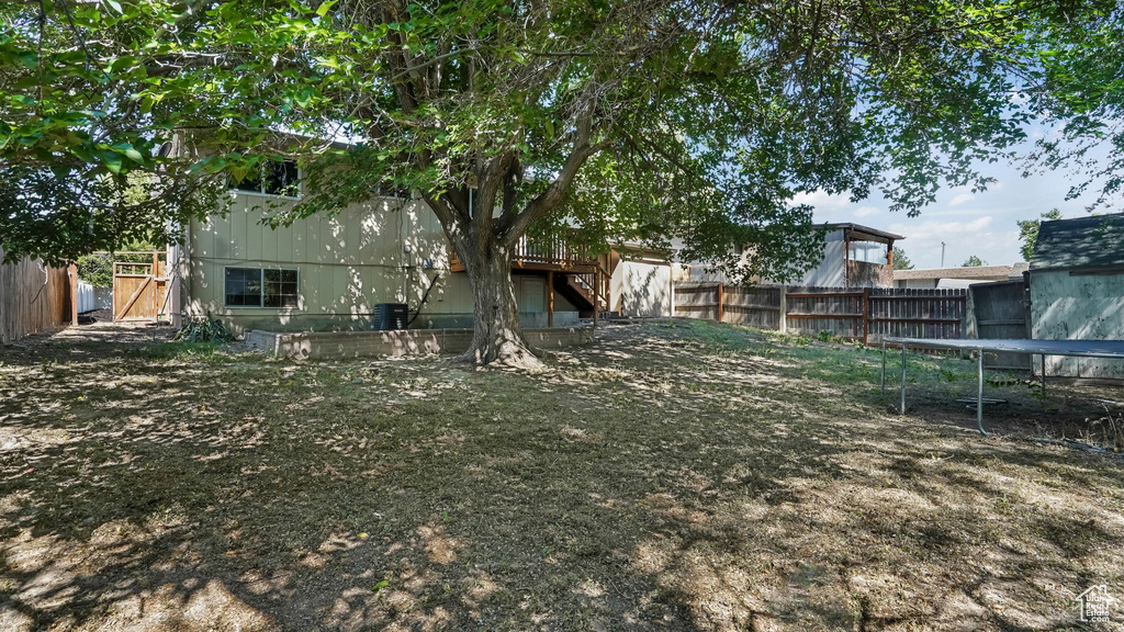 Fenced backyard with a trampoline