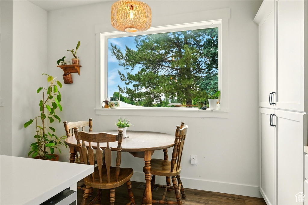 Dining space with wood finished floors and baseboards