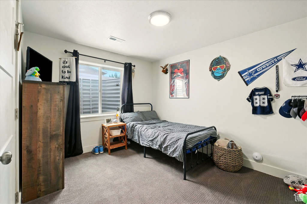 Bedroom with carpet floors and baseboards