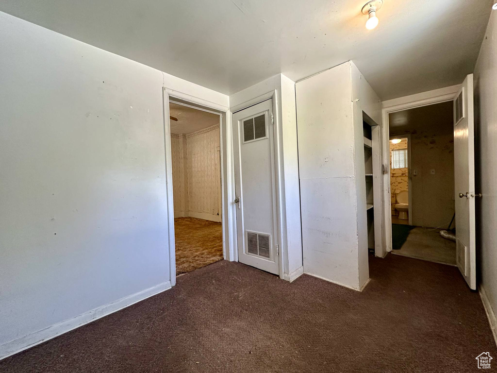 Unfurnished bedroom featuring carpet and baseboards