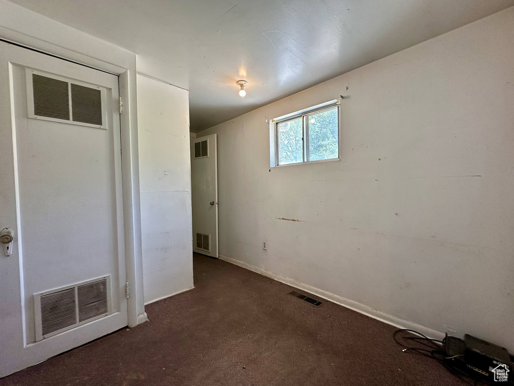Unfurnished bedroom featuring carpet floors and baseboards