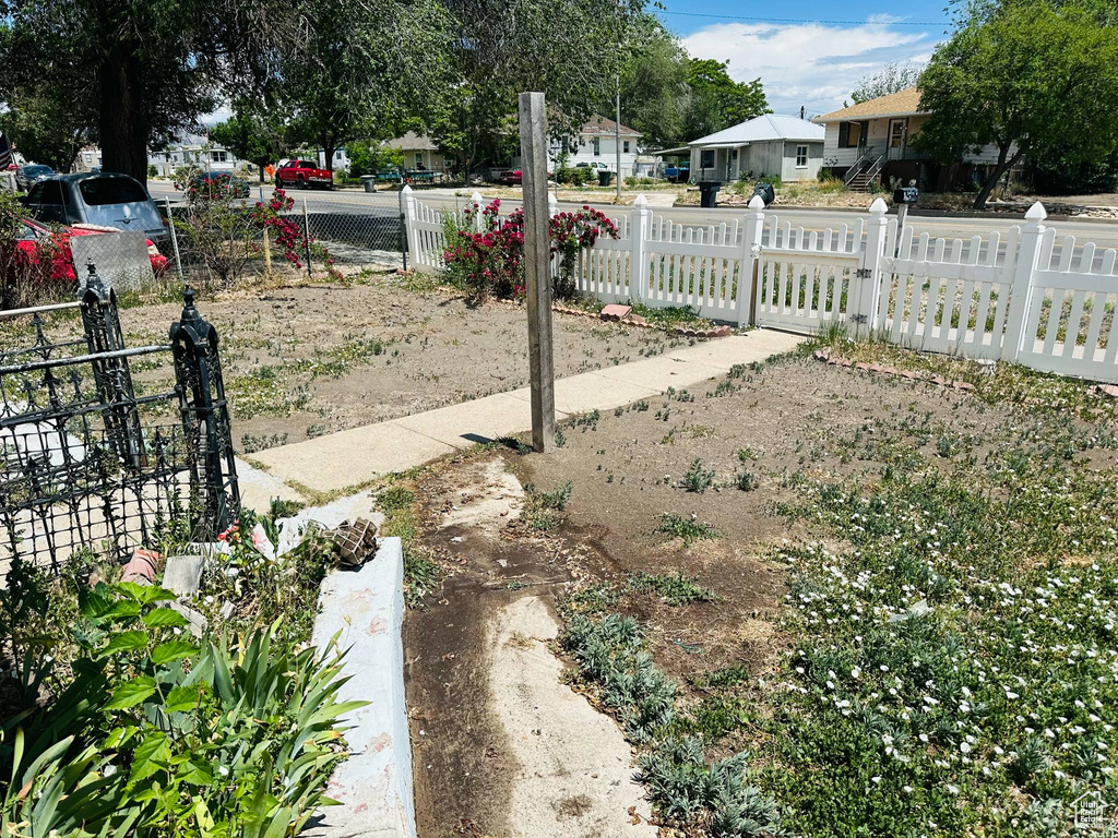 Fenced front yard with a residential view