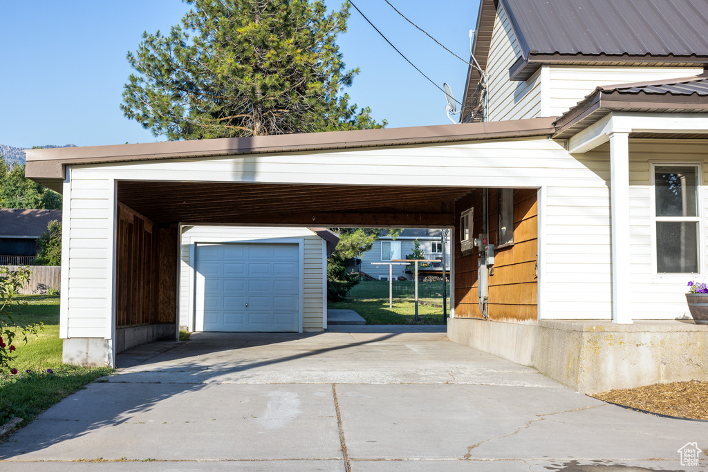 Garage featuring concrete driveway