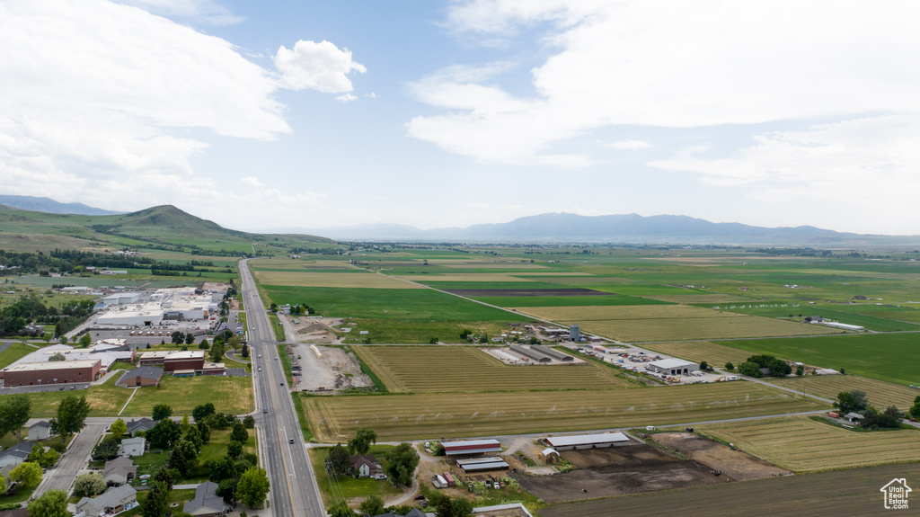View of property location with rows of crops, rural landscape, and mountains