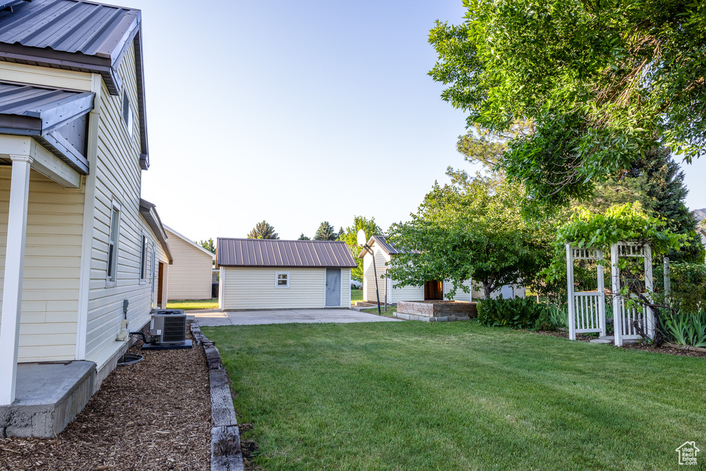 View of grassy yard featuring a patio