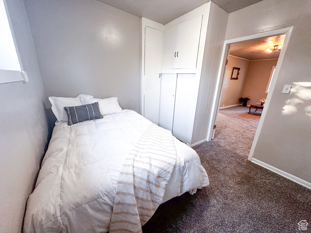 Carpeted bedroom featuring baseboards