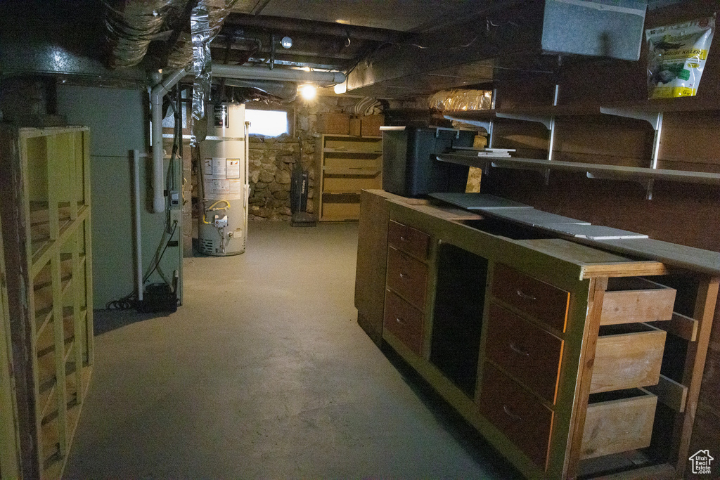 Unfinished basement featuring water heater