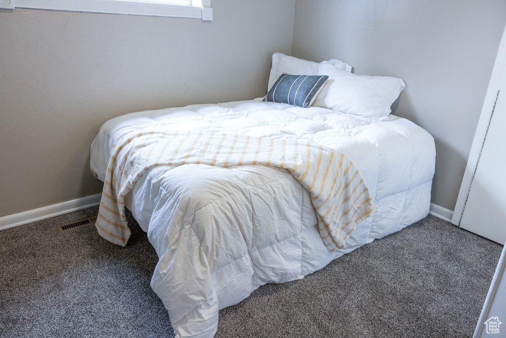Carpeted bedroom featuring baseboards