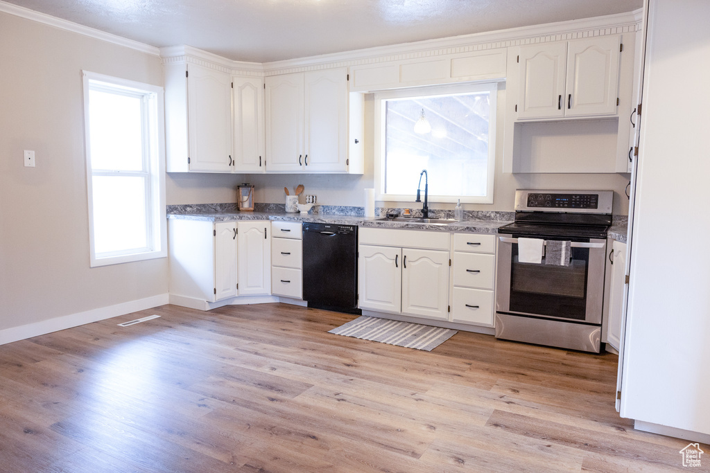 Kitchen featuring dishwasher, stainless steel electric range oven, white cabinets, light wood finished floors, and crown molding
