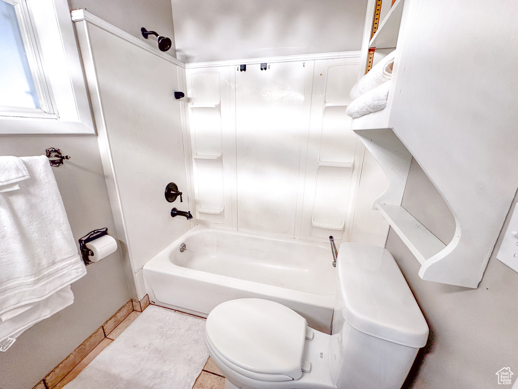 Bathroom with shower / bathtub combination and tile patterned flooring