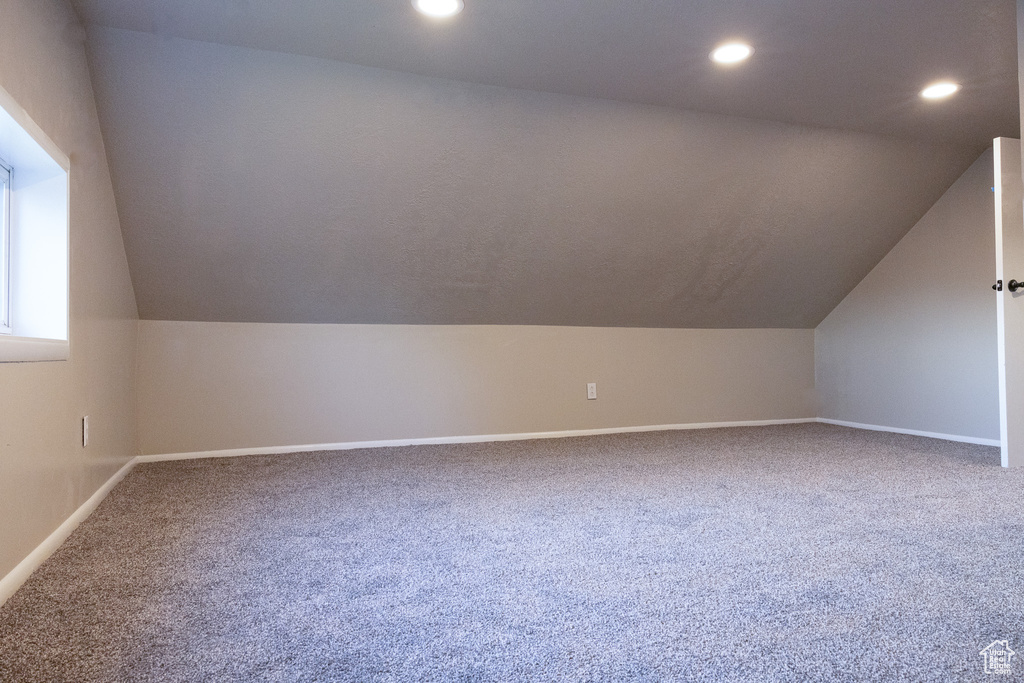 Additional living space with vaulted ceiling, carpet floors, and recessed lighting