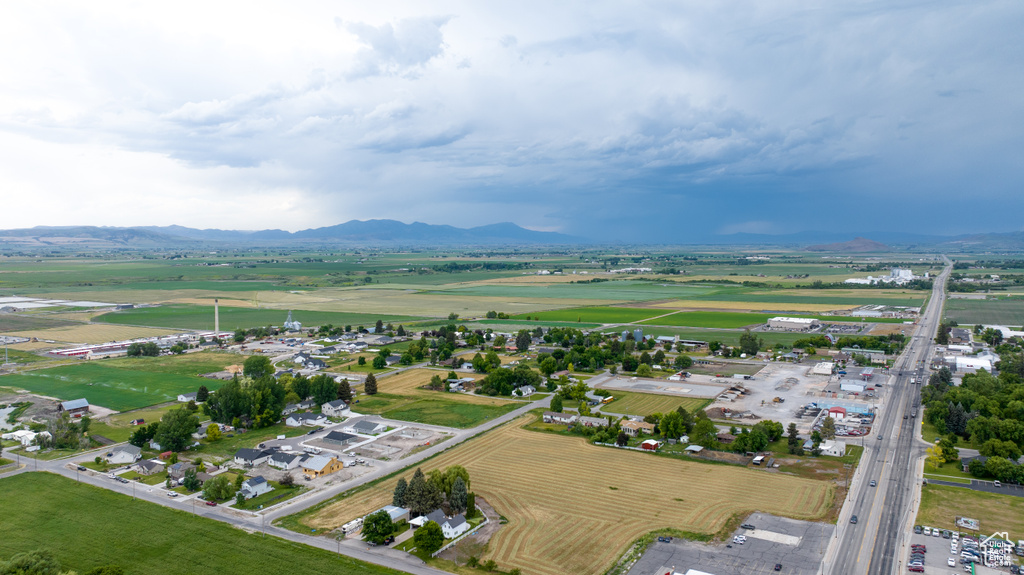 Aerial view of property and surrounding area featuring mountains