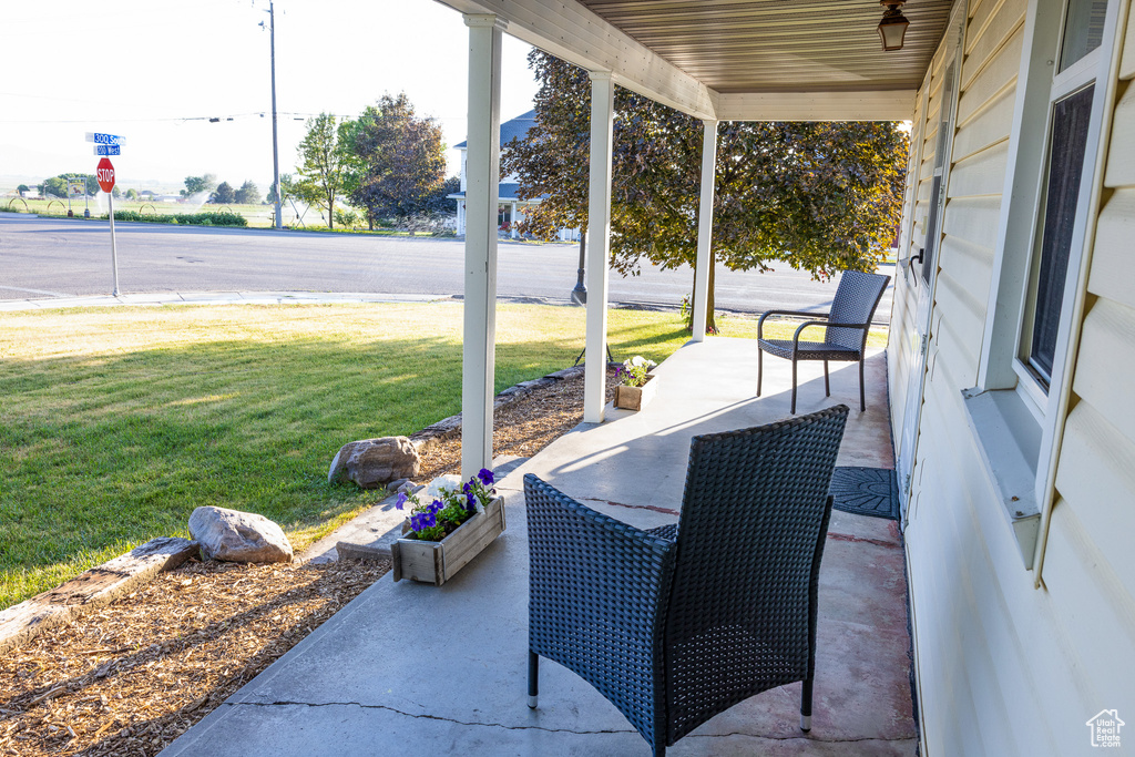Porch featuring a yard