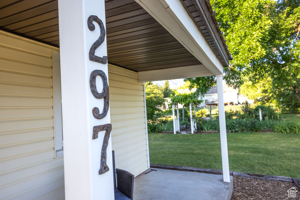 View of exterior entry featuring a lawn