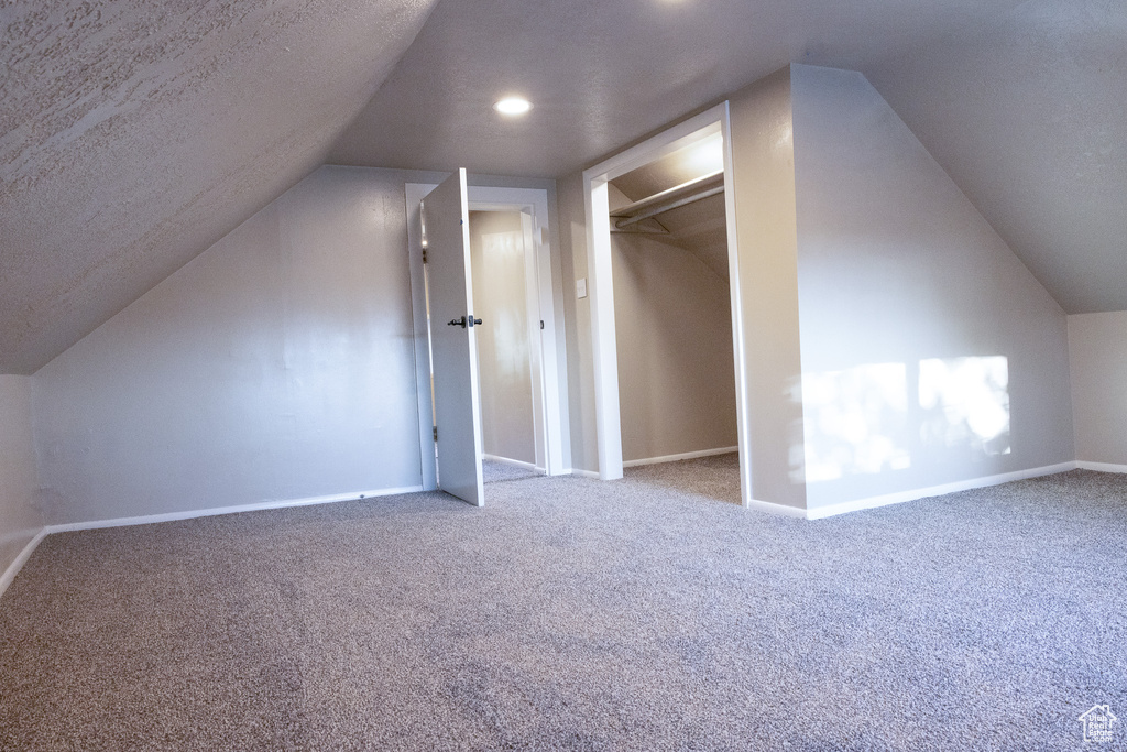 Bonus room featuring carpet, lofted ceiling, a textured ceiling, and recessed lighting