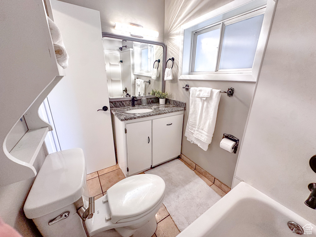 Full bathroom featuring vanity, a tub, tile patterned flooring, and a shower