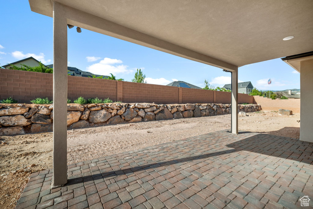Fenced backyard with a patio area