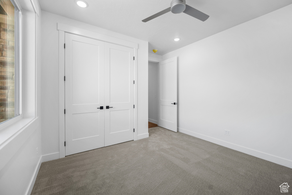 Unfurnished bedroom with carpet, recessed lighting, a closet, and a ceiling fan