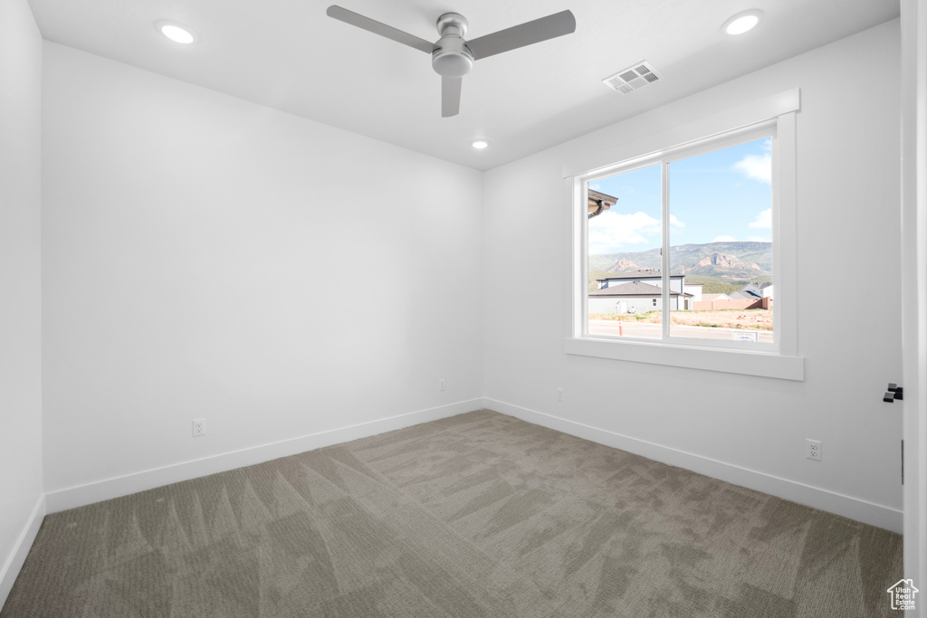 Empty room with carpet flooring, ceiling fan, and recessed lighting