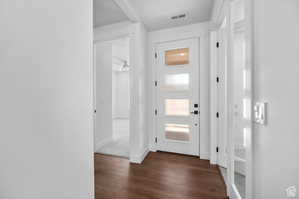 Hallway featuring dark wood-style floors and baseboards