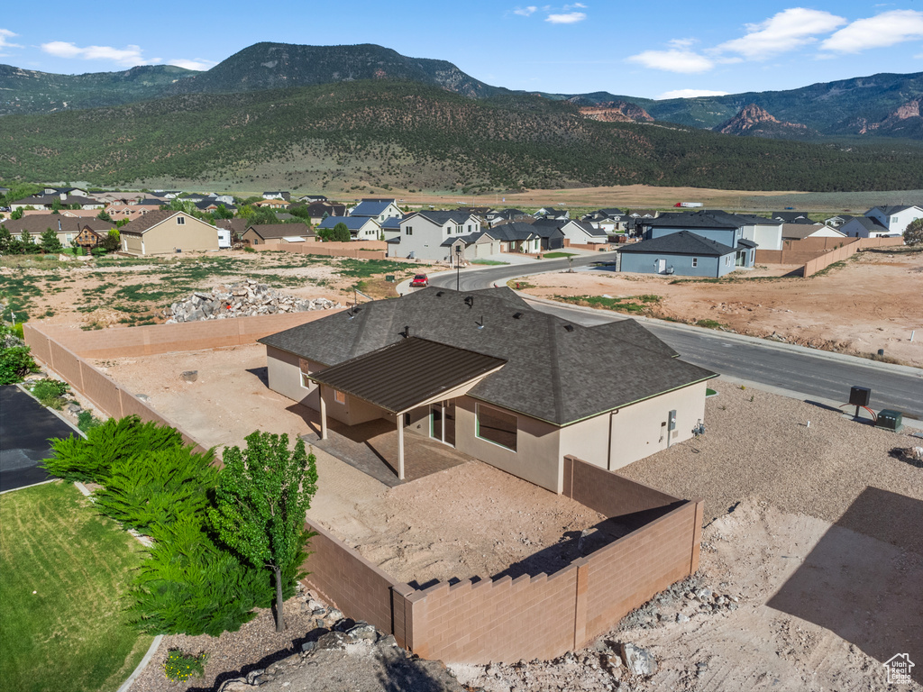 View of mountain backdrop featuring nearby suburban area