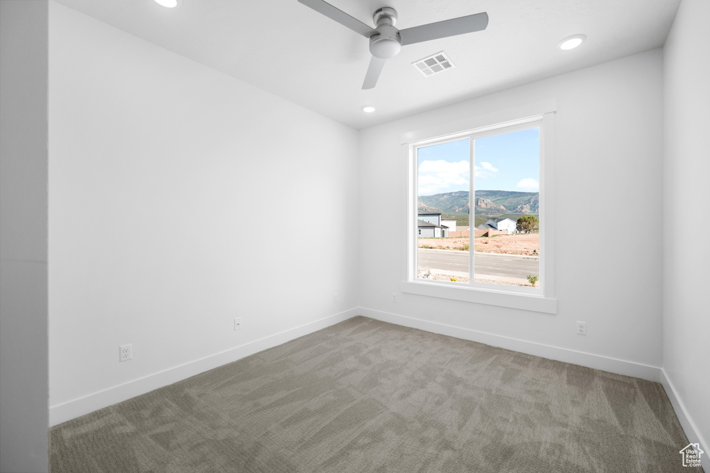 Empty room with carpet flooring, ceiling fan, and recessed lighting