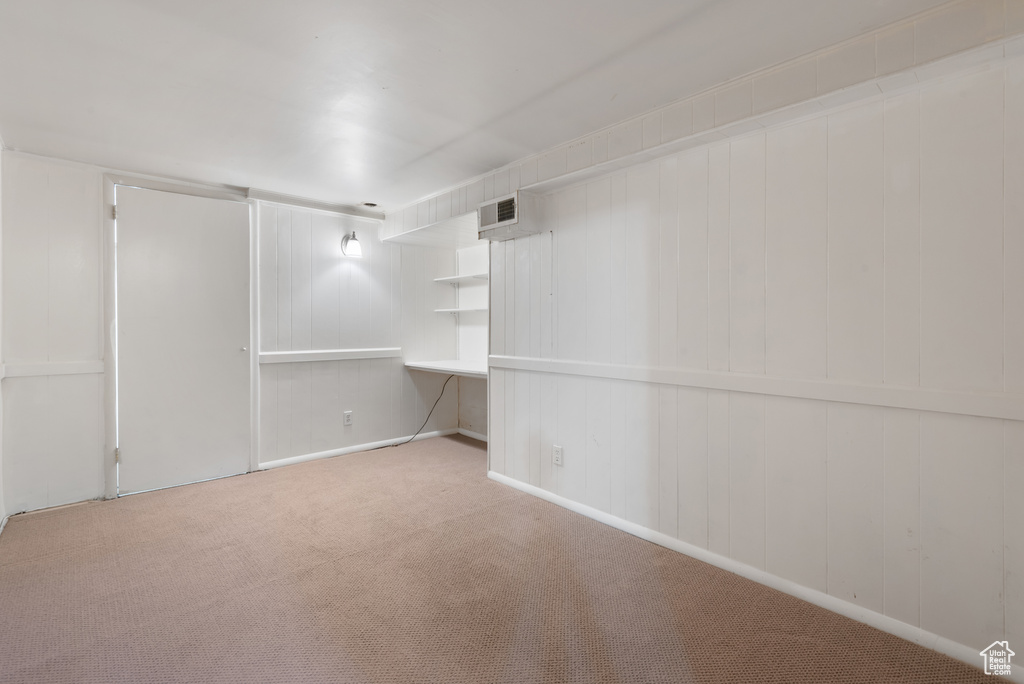 Empty room with carpet and baseboards