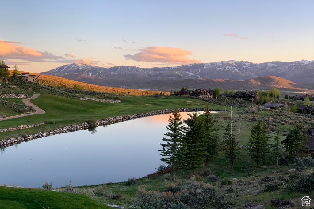 Mountain view featuring a nearby body of water and a golf club