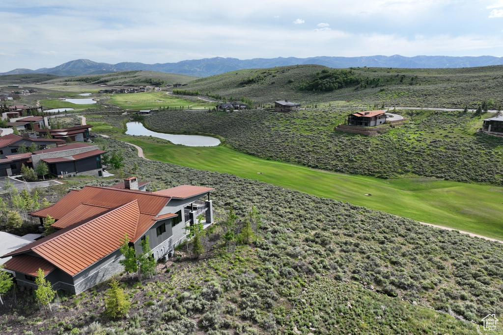 View of mountain background featuring a large body of water and a local golf course