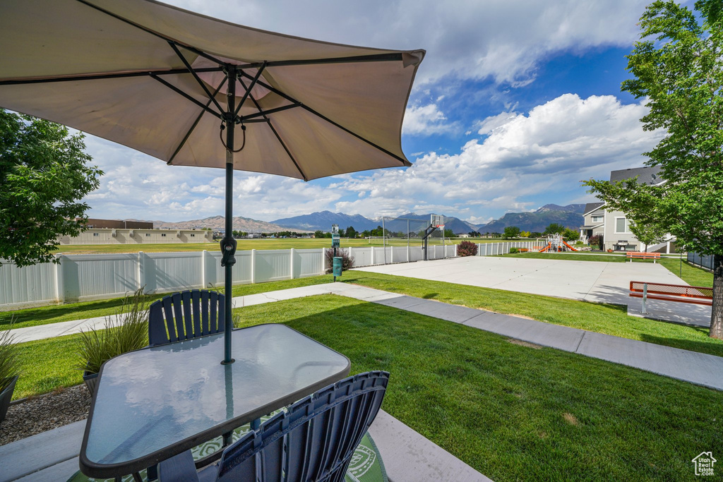 View of yard with a mountain view, a playground, and outdoor dining area