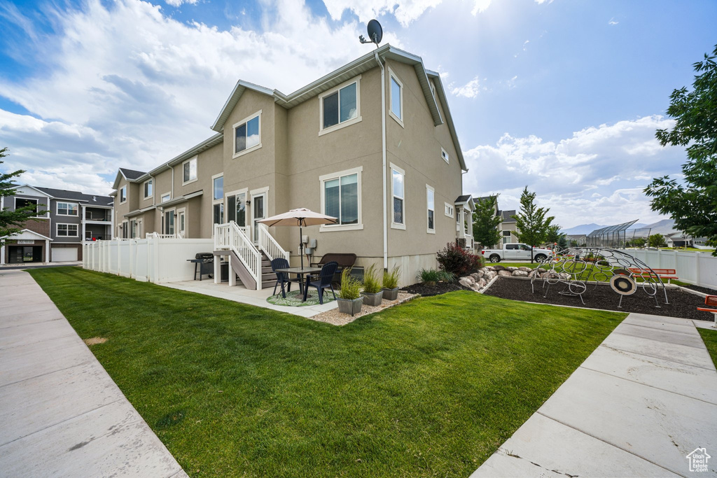 Rear view of property with a patio, a residential view, and stucco siding