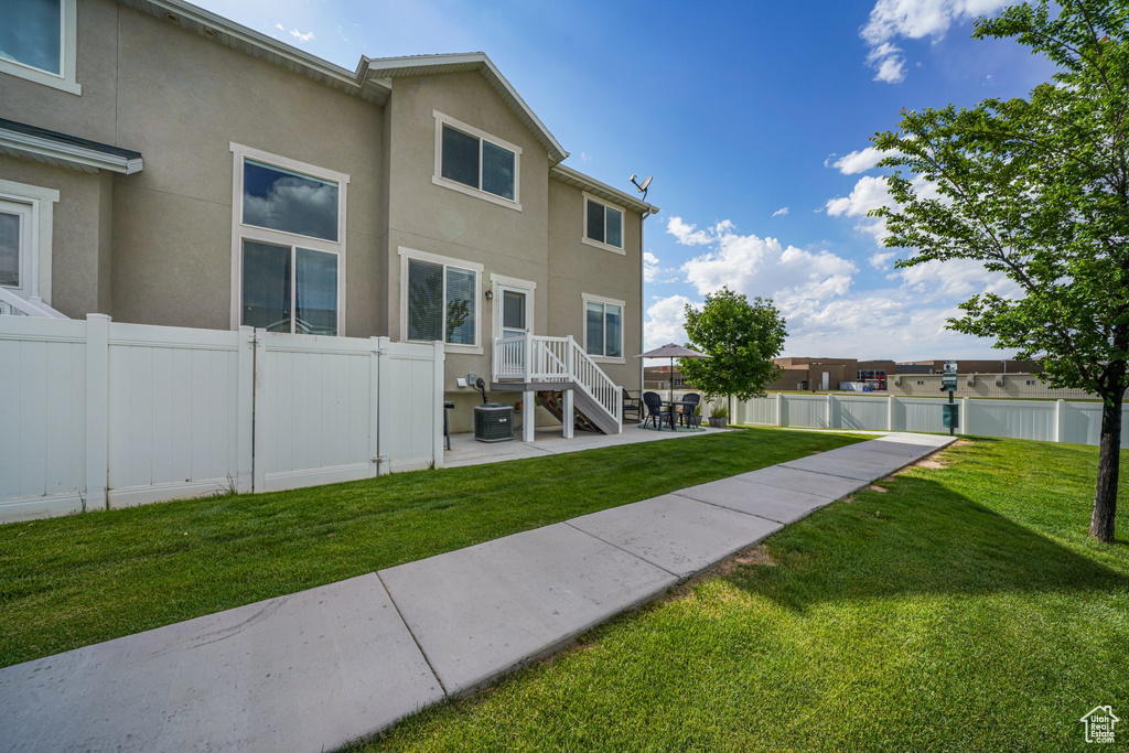 Rear view of property with a patio area and stucco siding