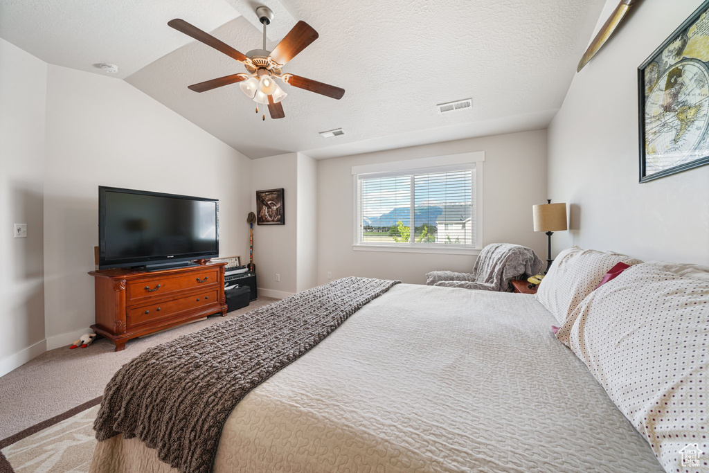 Bedroom with light carpet, lofted ceiling, and a ceiling fan
