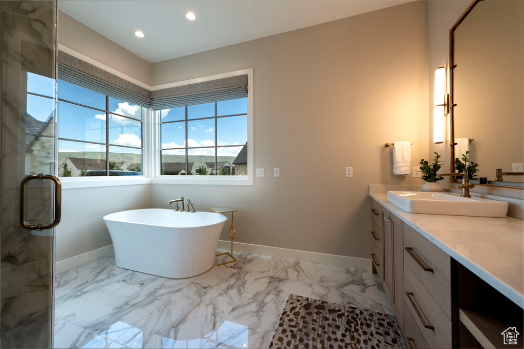Bathroom with vanity, marble finish floors, a soaking tub, recessed lighting, and a stall shower