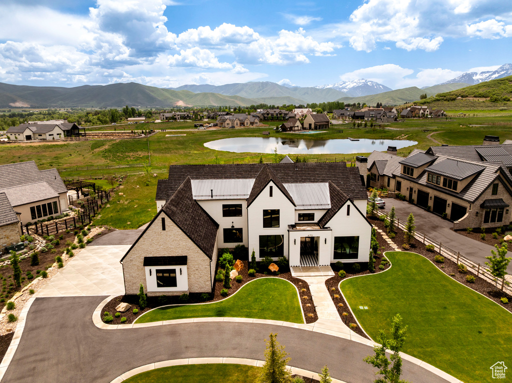 Aerial perspective of suburban area with a water and mountain view