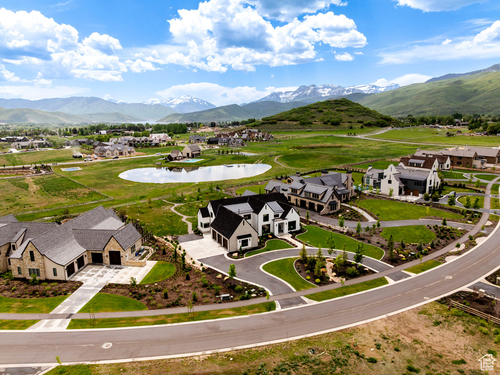 Aerial view of residential area featuring a water and mountain view