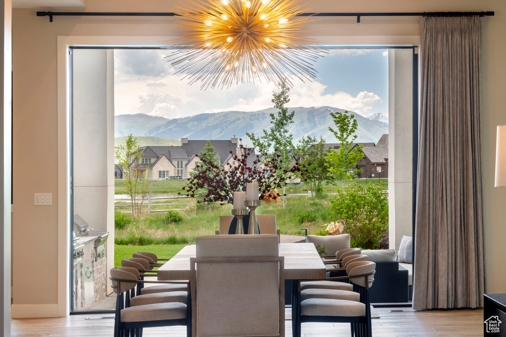 Dining area featuring a mountain view, wood finished floors, and a chandelier