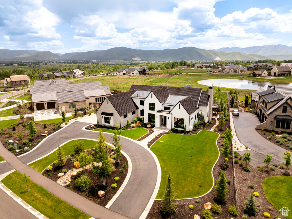 Aerial view of residential area featuring a water and mountain view