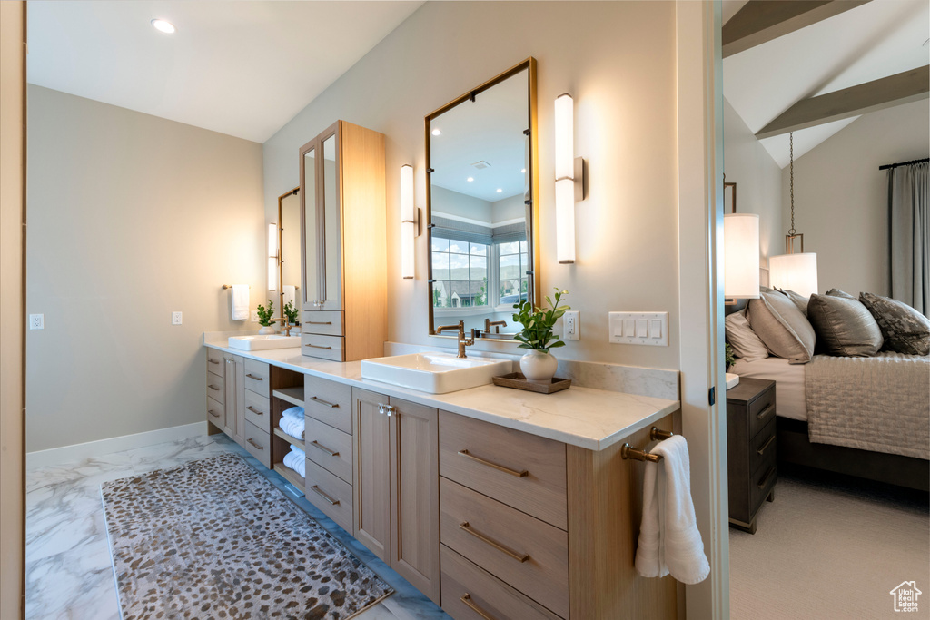 Full bathroom featuring vanity, recessed lighting, vaulted ceiling, and marble finish floors