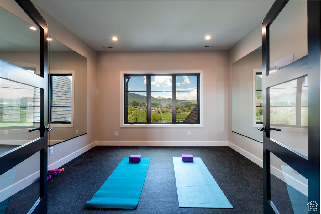 Exercise room featuring recessed lighting and dark colored carpet