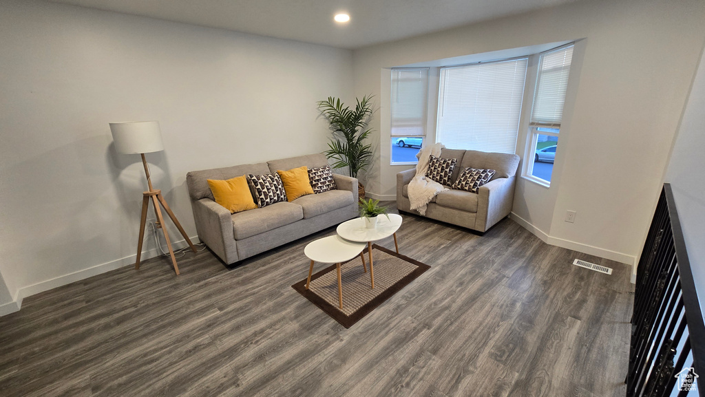 Living area with wood finished floors and recessed lighting